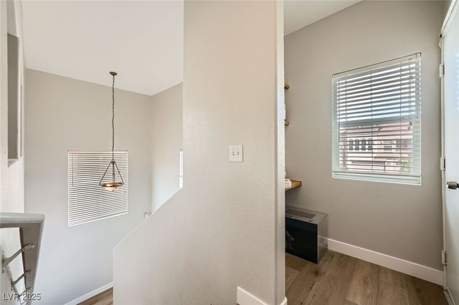 Stairway featuring baseboards and wood finished floors and desk | Image 21