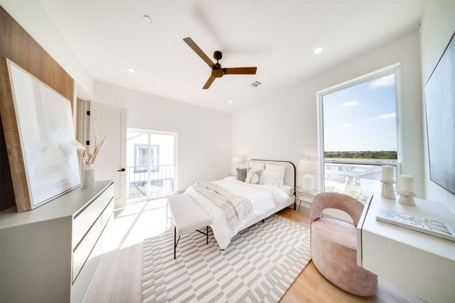 Bedroom with light hardwood / wood-style floors, multiple windows, and ceiling fan | Image 19