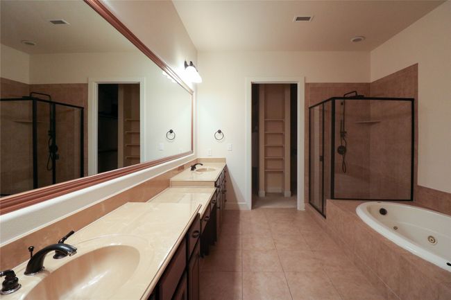 Full bath with tile patterned floors, visible vents, a sink, and a stall shower | Image 19