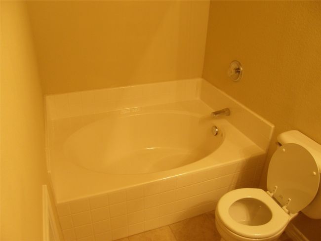 Bathroom featuring a bath and tile patterned floors | Image 12
