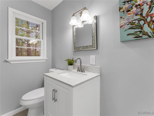 Half bath featuring tile patterned flooring, baseboards, vanity, and toilet | Image 15