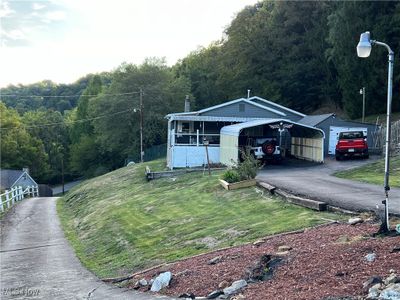 View of front of home with a front yard and covered porch | Image 1