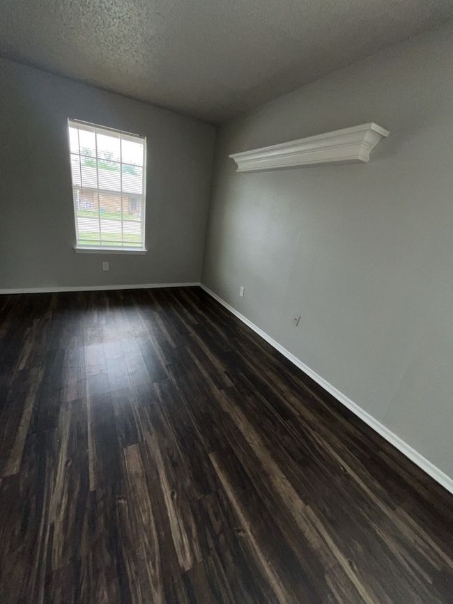 Living room featuring dark wood-style floors, baseboards, and a textured ceiling | Image 5
