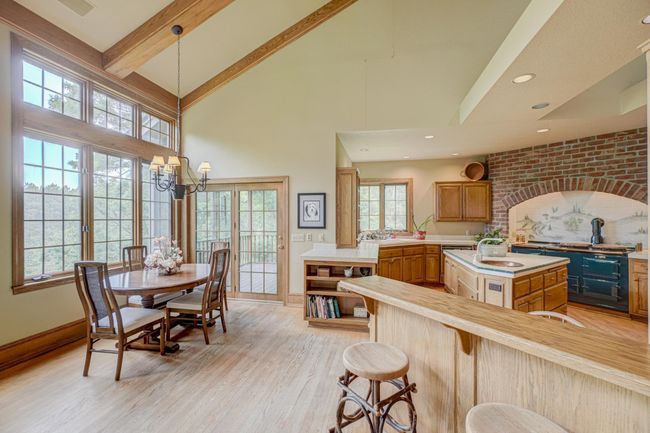 The heart of the home—the gourmet kitchen—features a rare AGA stove and a stunning copper-faced refrigerator | Image 11