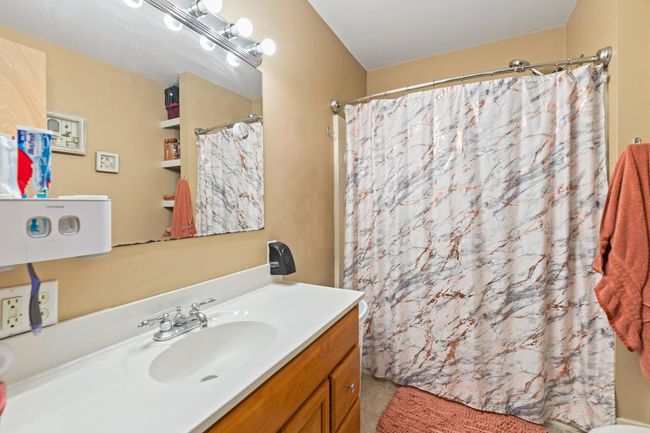 Full bath with vanity and curtained shower | Image 13