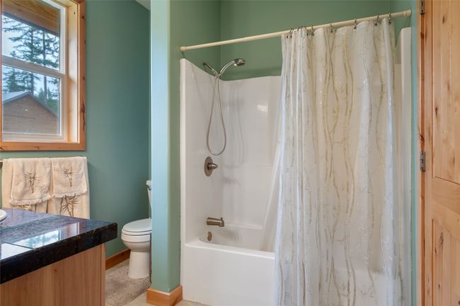 Bathroom featuring vanity and shower / bath combo | Image 51