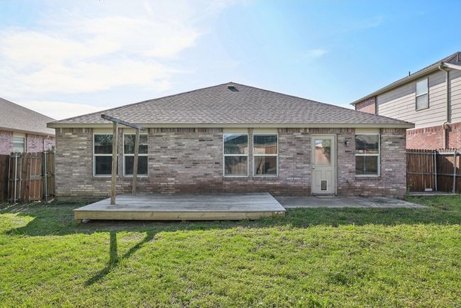 Rear view of house with a lawn, brick siding, and a fenced backyard | Image 31