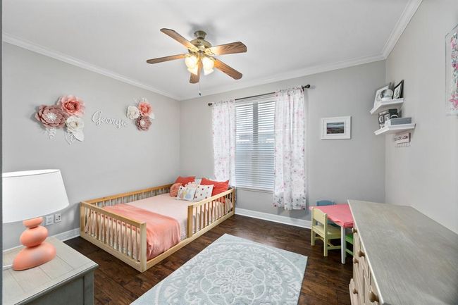 Secondary bedroom with a closet is located downstairs and can also be used as an office or bonus space. | Image 30