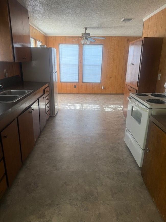 Kitchen featuring a electric stove/oven and fridge | Image 5