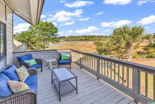 Wooden terrace with a water view and outdoor lounge area | Image 24