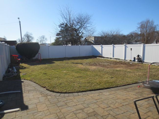 View of yard with a patio area and a fenced backyard | Image 5
