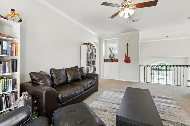 Living room with a ceiling fan, carpet floors, and ornamental molding | Image 33