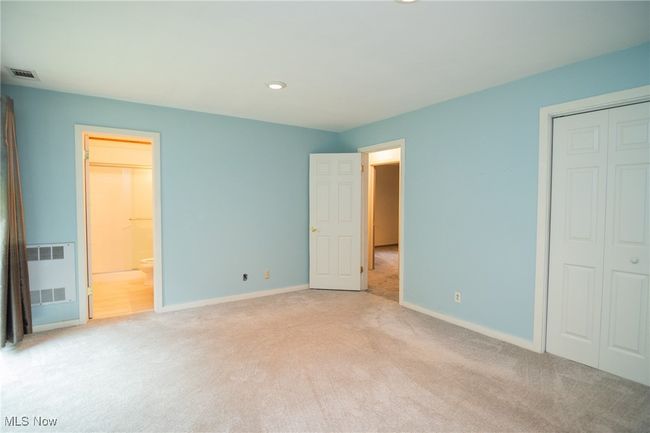 Unfurnished bedroom with light carpet, baseboards, a closet, recessed lighting, and ensuite bathroom | Image 14