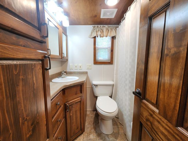 Bathroom with full tub and shower and plenty of storage | Image 10