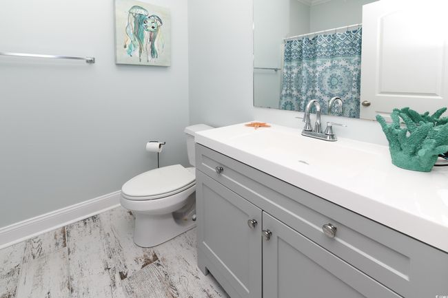 Full bath with a shower with shower curtain, vanity, toilet, and baseboards | Image 18