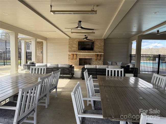 Outdoor Dining/Lounge with Fireplace and TV's at Amenity Center | Image 44