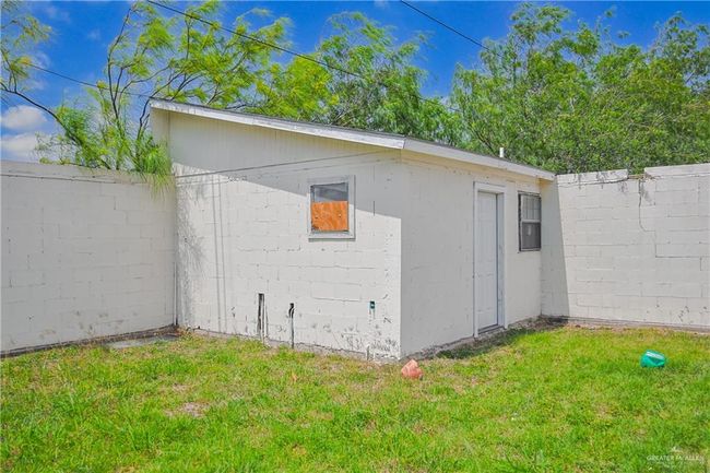 View of home's exterior featuring a lawn, an outbuilding, and a fenced backyard | Image 26