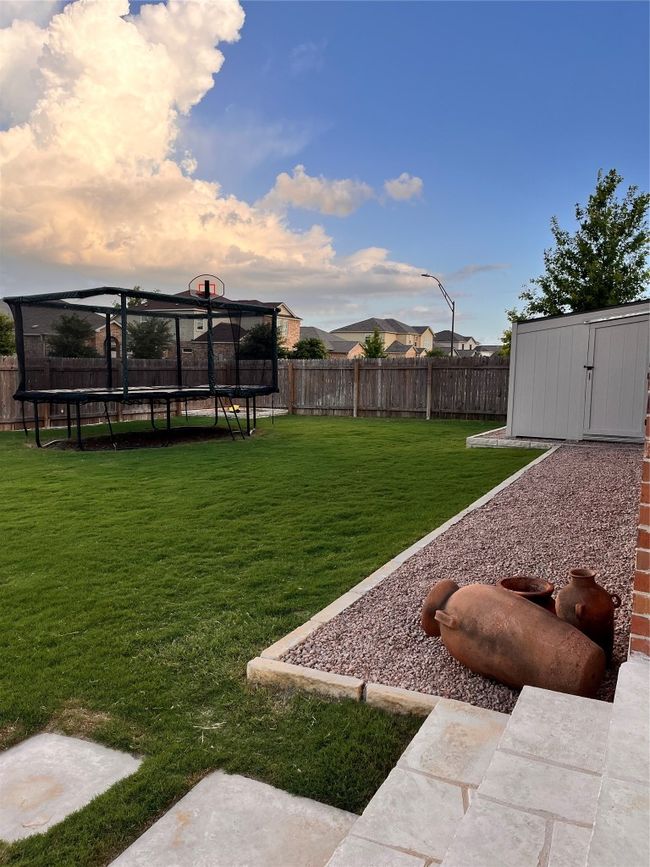 Fenced backyard with a trampoline | Image 35