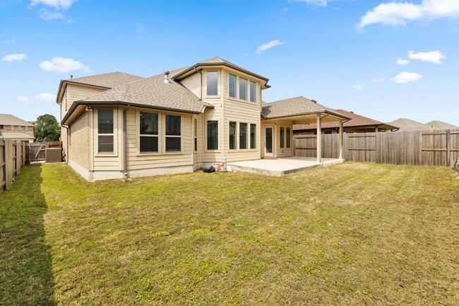 Back of house with a patio, a lawn, a fenced backyard, and roof with shingles | Image 37