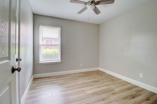 Spare room with light wood-style floors and a ceiling fan | Image 18