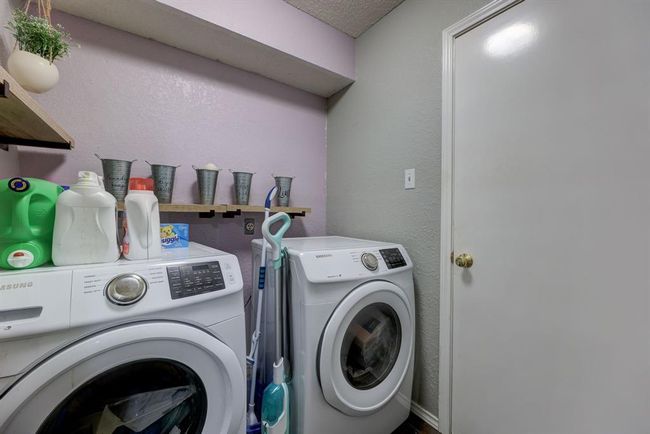 Laundry area featuring washer and clothes dryer | Image 12