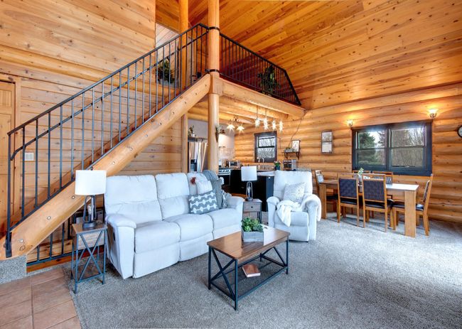 Open living room, dining room and kitchen, Note the grand staircase leading to the upper level loft and bedroom #3 | Image 11