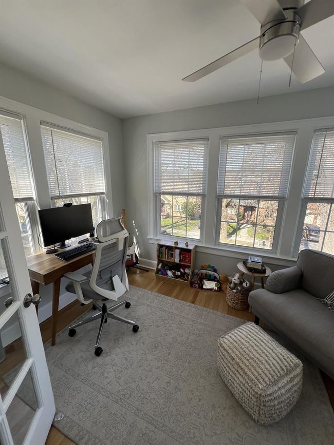 Office space featuring wood finished floors, a ceiling fan, and plenty of natural light | Image 16