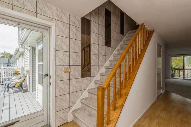 Entry with staircase, tile walls, wood finished floors | Image 5