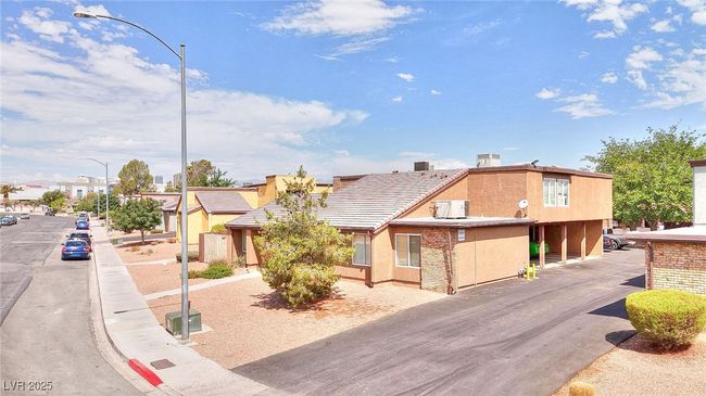 View of front of house with stucco siding and a tiled roof | Image 17