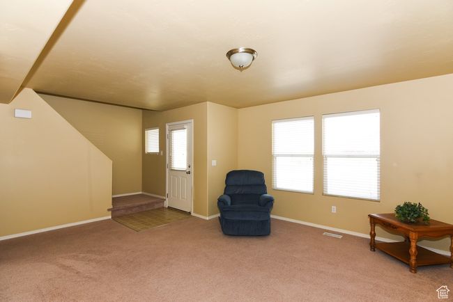 Unfurnished room with baseboards, visible vents, stairs, and carpet flooring | Image 11