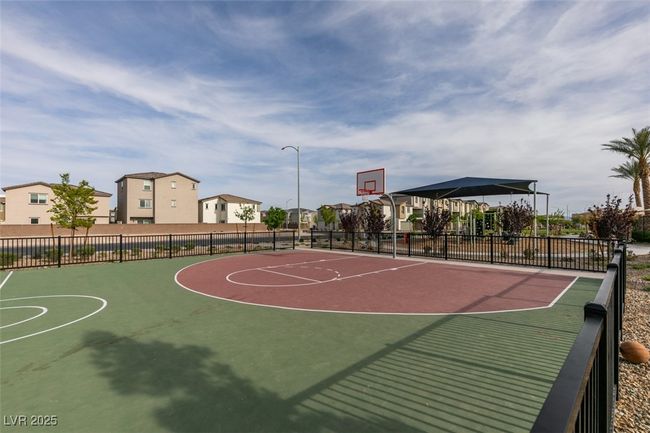 View of sport court with a residential view, fence, and community basketball court | Image 6