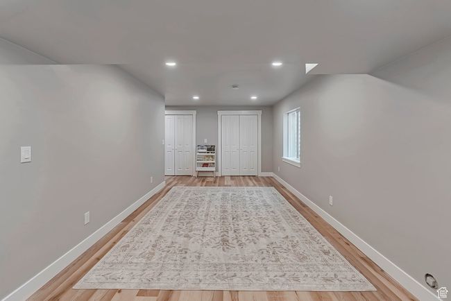 Basement featuring light wood-style flooring, baseboards, and recessed lighting | Image 26