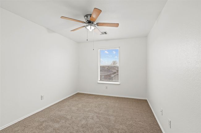 Carpeted spare room with visible vents, baseboards, and ceiling fan | Image 16
