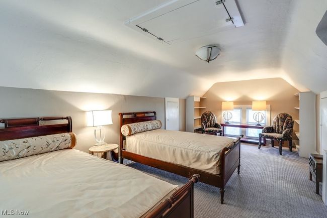 Bedroom featuring lofted ceiling, attic access, and carpet floors | Image 25