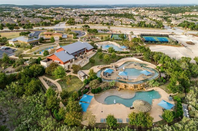 Aerial view of property and surrounding area with a pool and nearby suburban area | Image 17