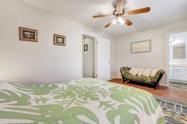 Bedroom featuring connected bathroom, a ceiling fan, and baseboards | Image 24