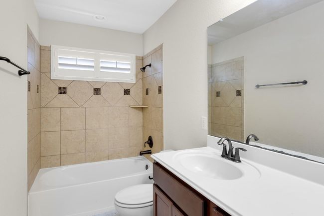 Bathroom with tub / shower combination, toilet, and vanity | Image 24