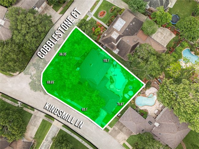 a corner property highlighted in green, featuring a spacious lot with a pool. | Image 33
