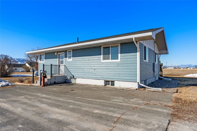 Plenty of parking space with a wide concrete driveway | Image 11