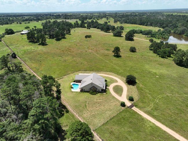 Aerial view of a beautiful rural property featuring a home with a pool. | Image 43