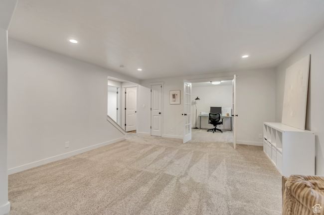 Unfurnished living room featuring recessed lighting, light carpet, and an office area | Image 27