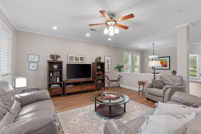 Living area with crown molding, ceiling fan, light wood-style flooring, baseboards, and recessed lighting | Image 7