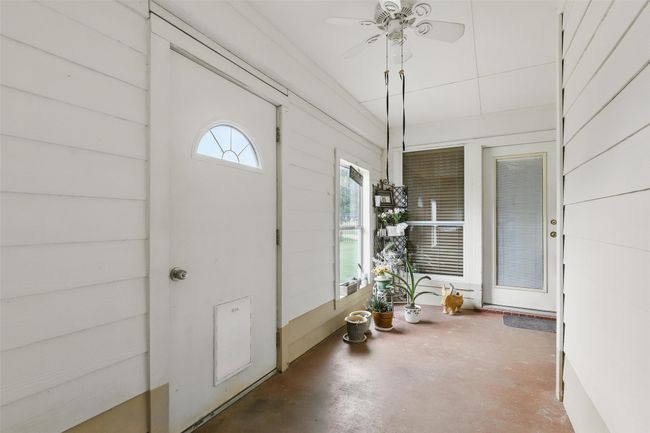 Doorway to property featuring a ceiling fan | Image 27
