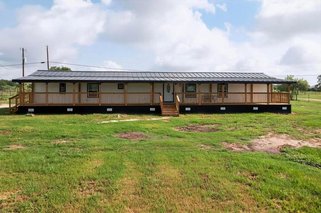 Rear view of house with large, covered patio/ metal roof | Image 39
