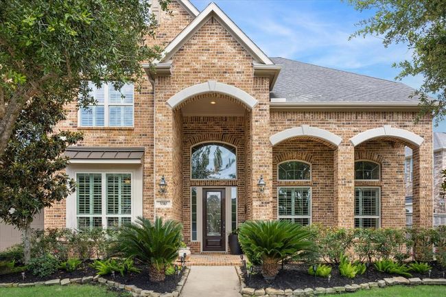Beautiful landscaping and brick stone curvatures greet you as you approach this lovely home. | Image 6
