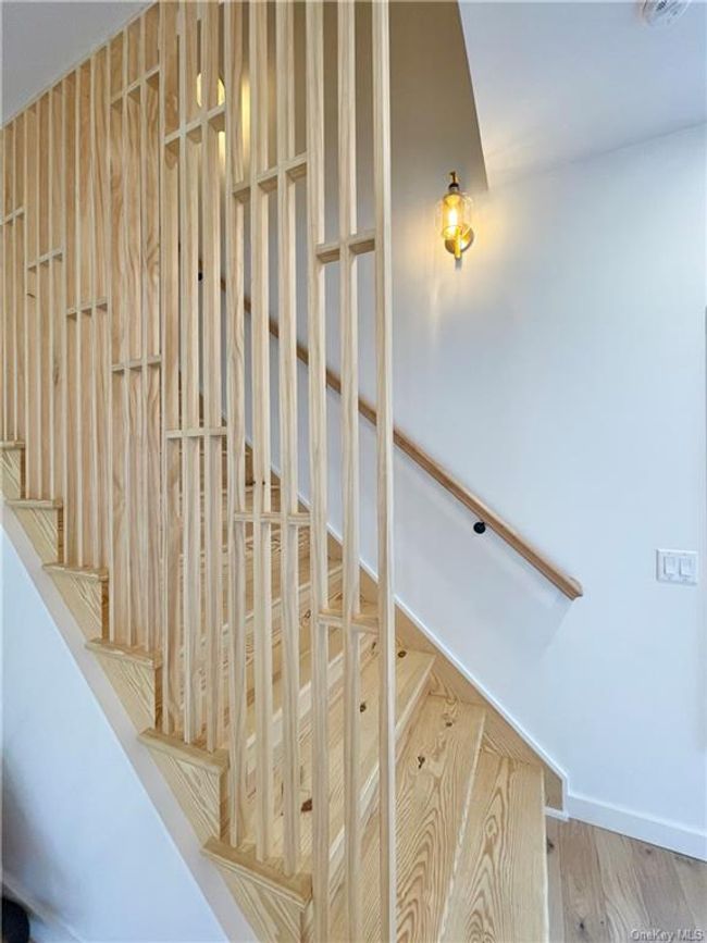 Example of the work we do. Not this house. Stairway featuring hardwood / wood-style flooring | Image 12