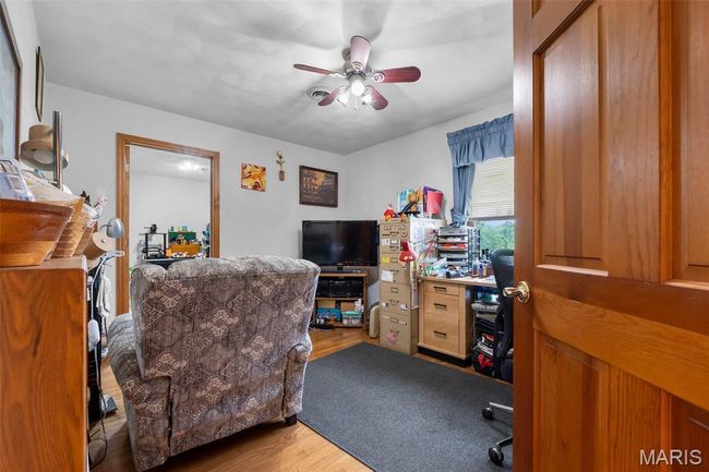 Office featuring wood finished floors and ceiling fan | Image 78
