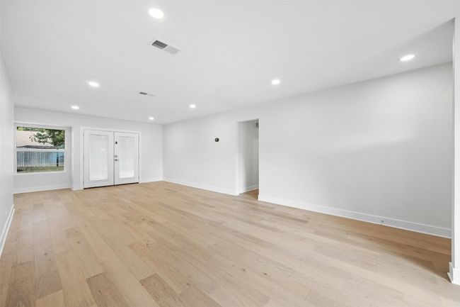 Unfurnished living room featuring light wood-type flooring and recessed lighting | Image 10