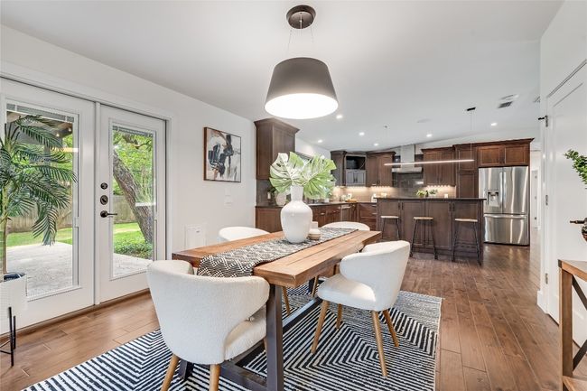The dining area offers abundant space for a table of any size and sits alongside the doors to the back patio. | Image 5