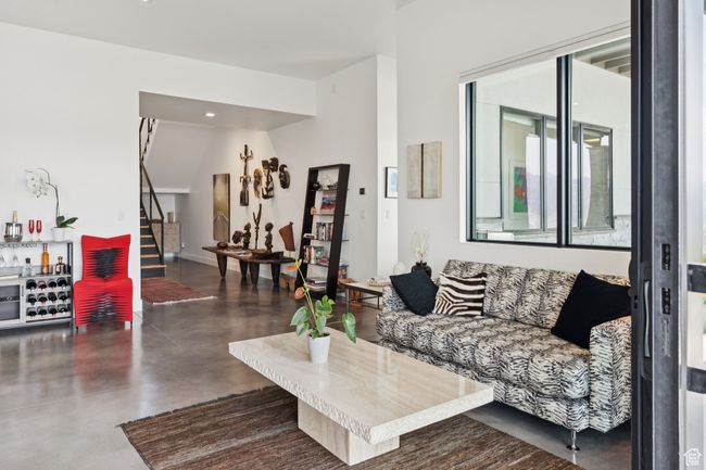 Living area featuring stairs, concrete flooring, and recessed lighting | Image 64